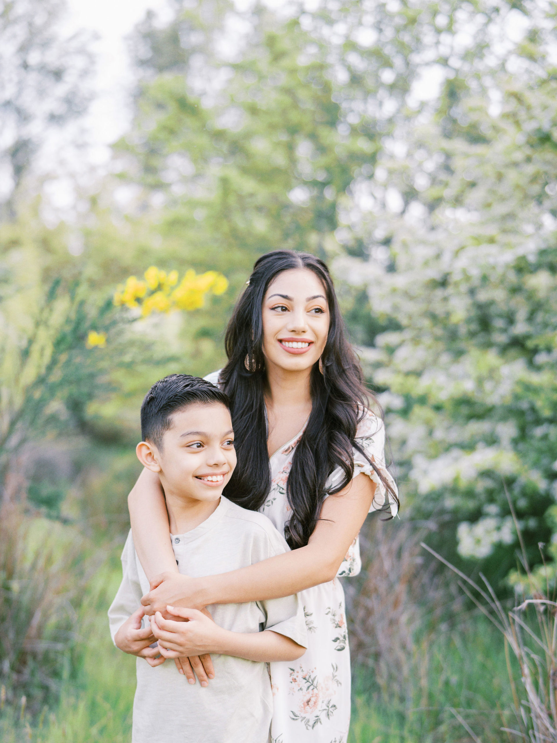 Mother hugging son in a park in Seattle