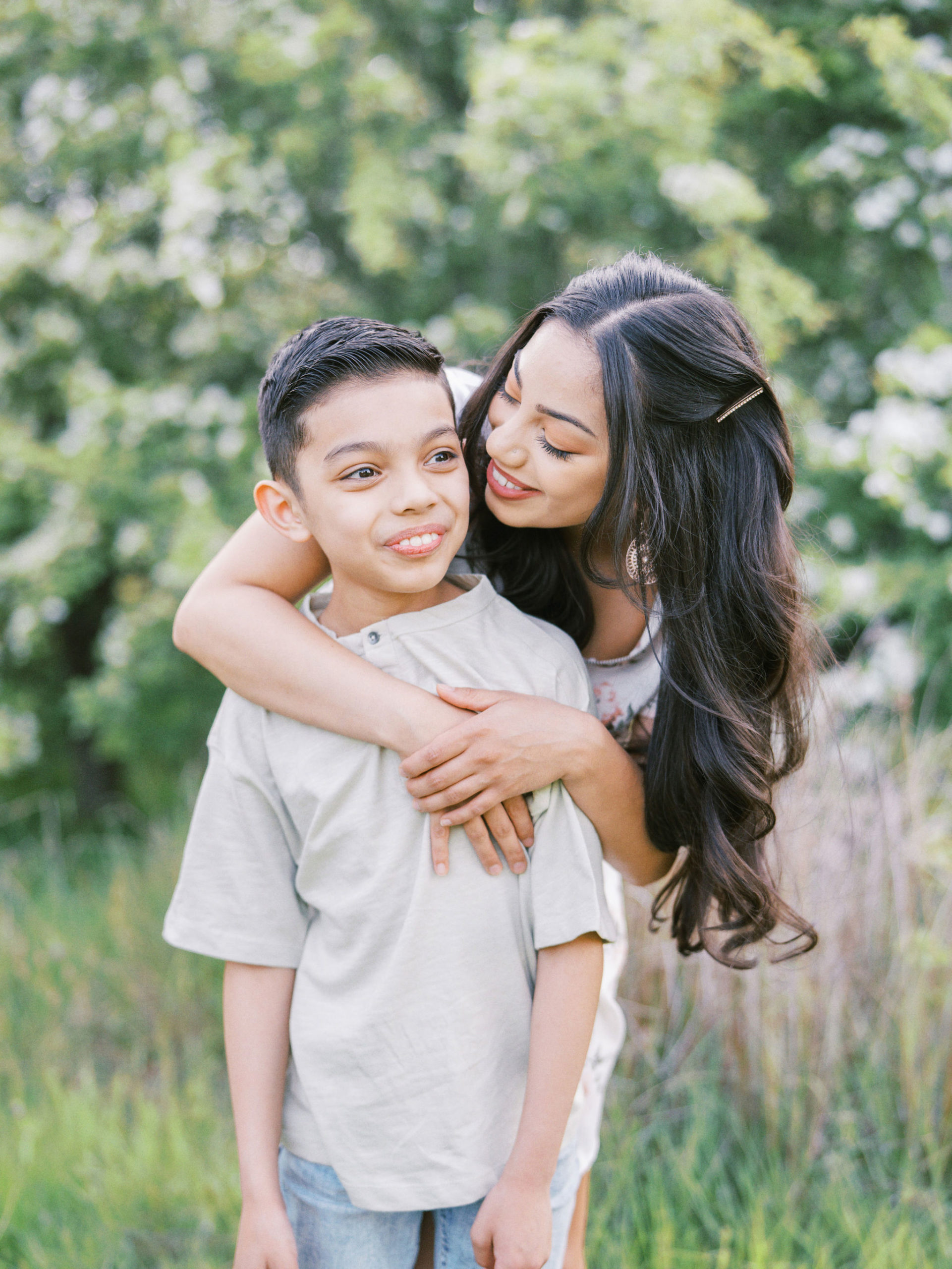 Mother embracing son in a park in Seattle