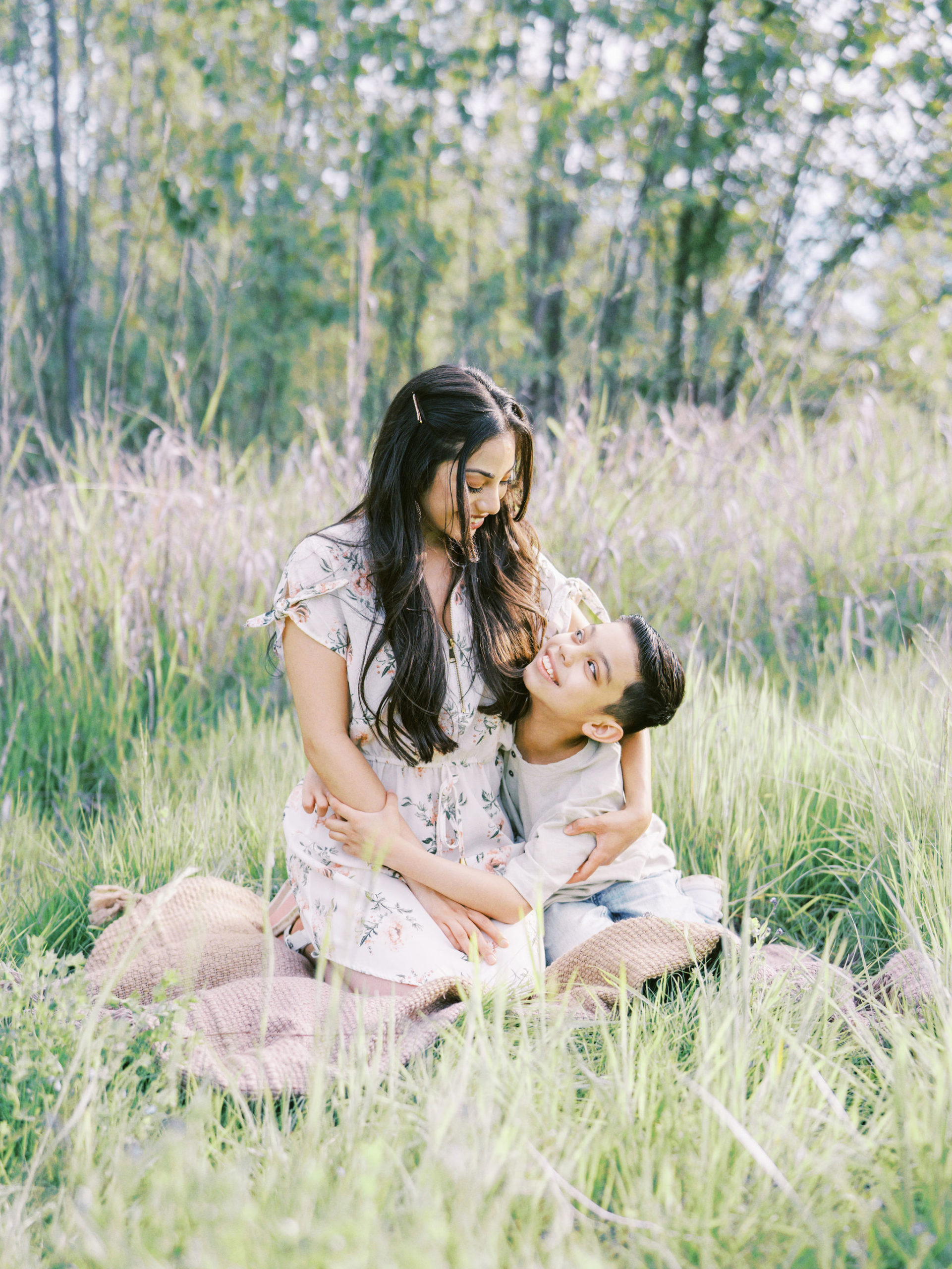 Mother and son hugging on a blanket