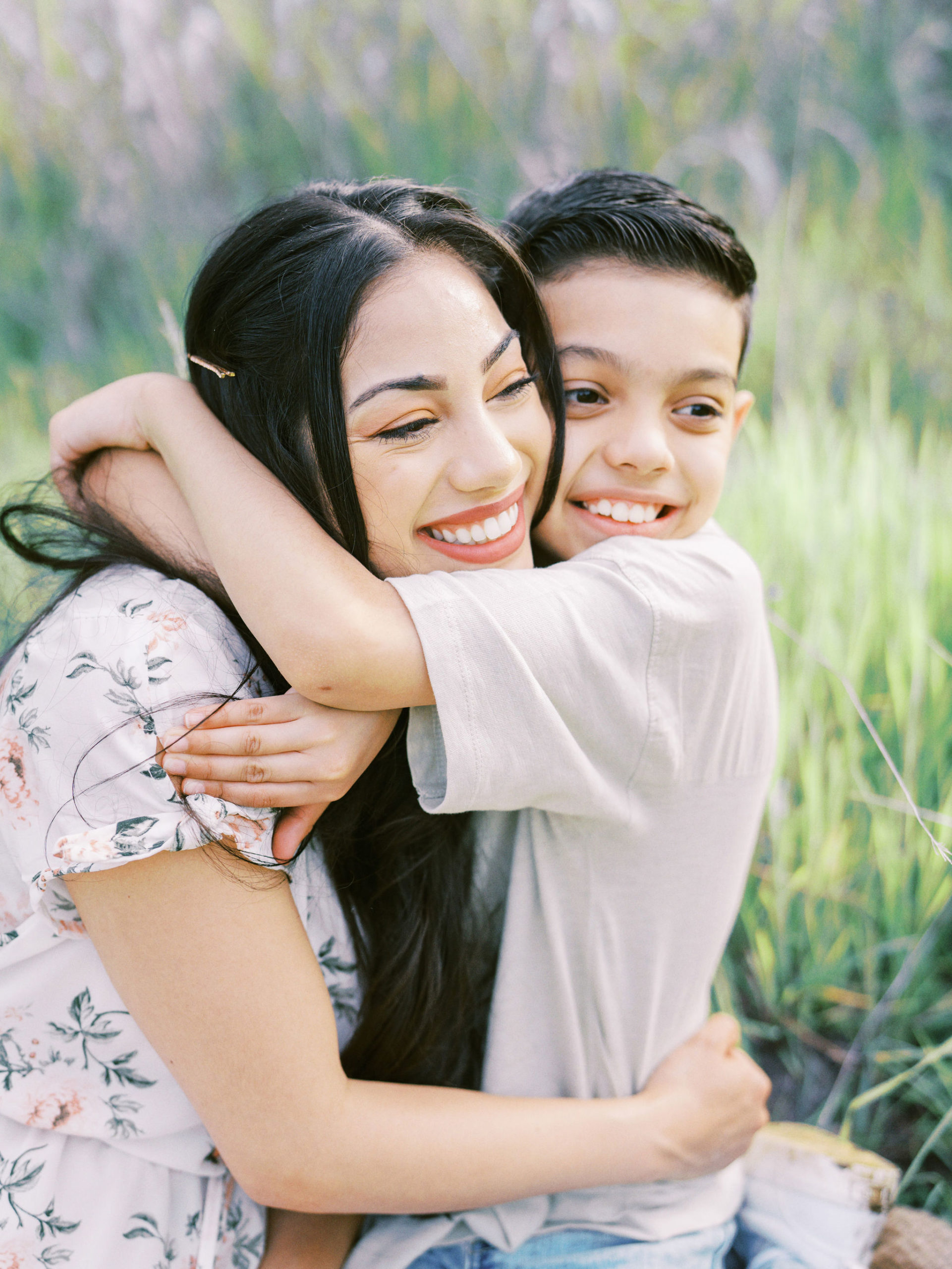 Mother and son hugging and looking away