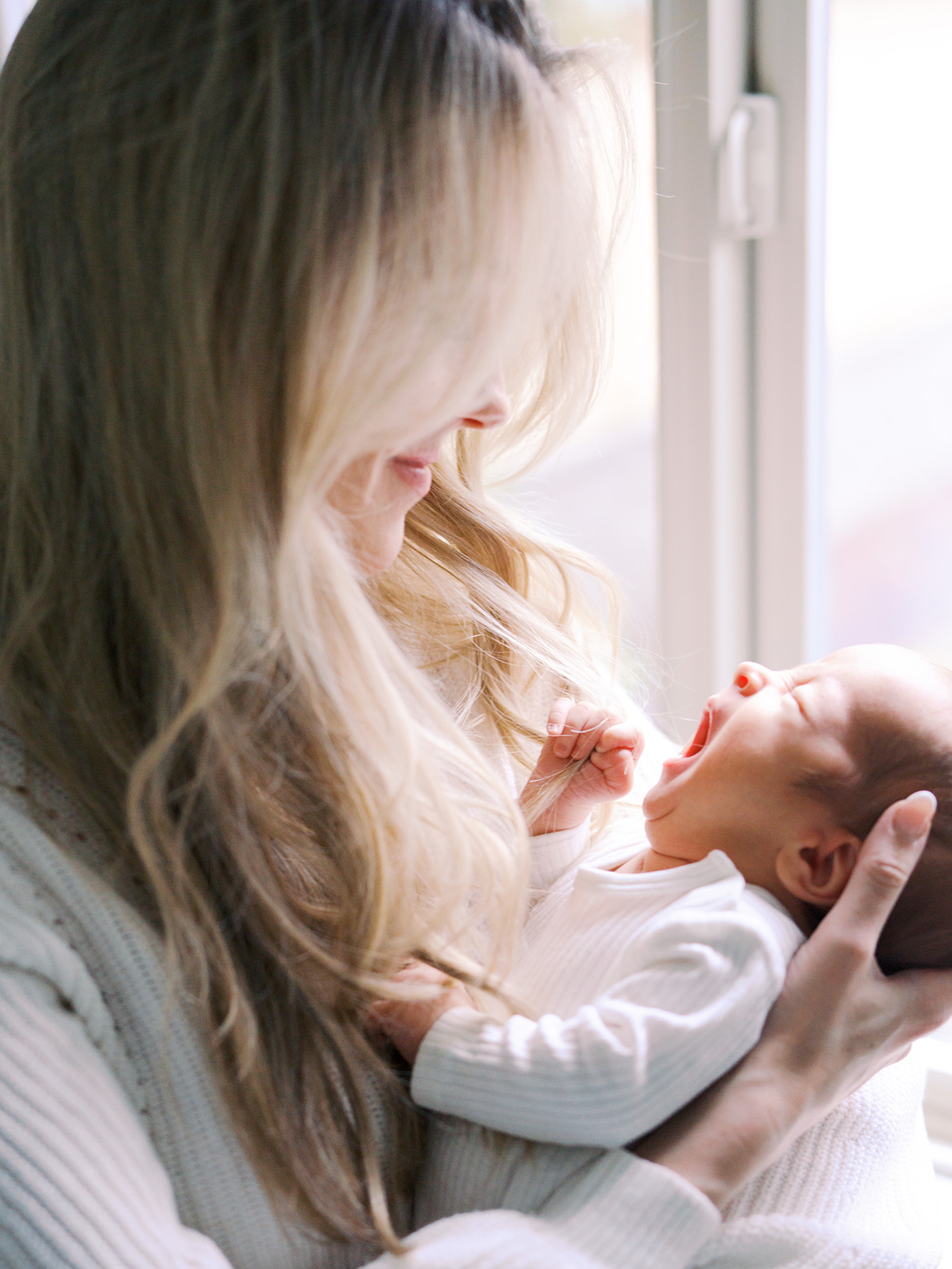 Mom holds a yawning baby