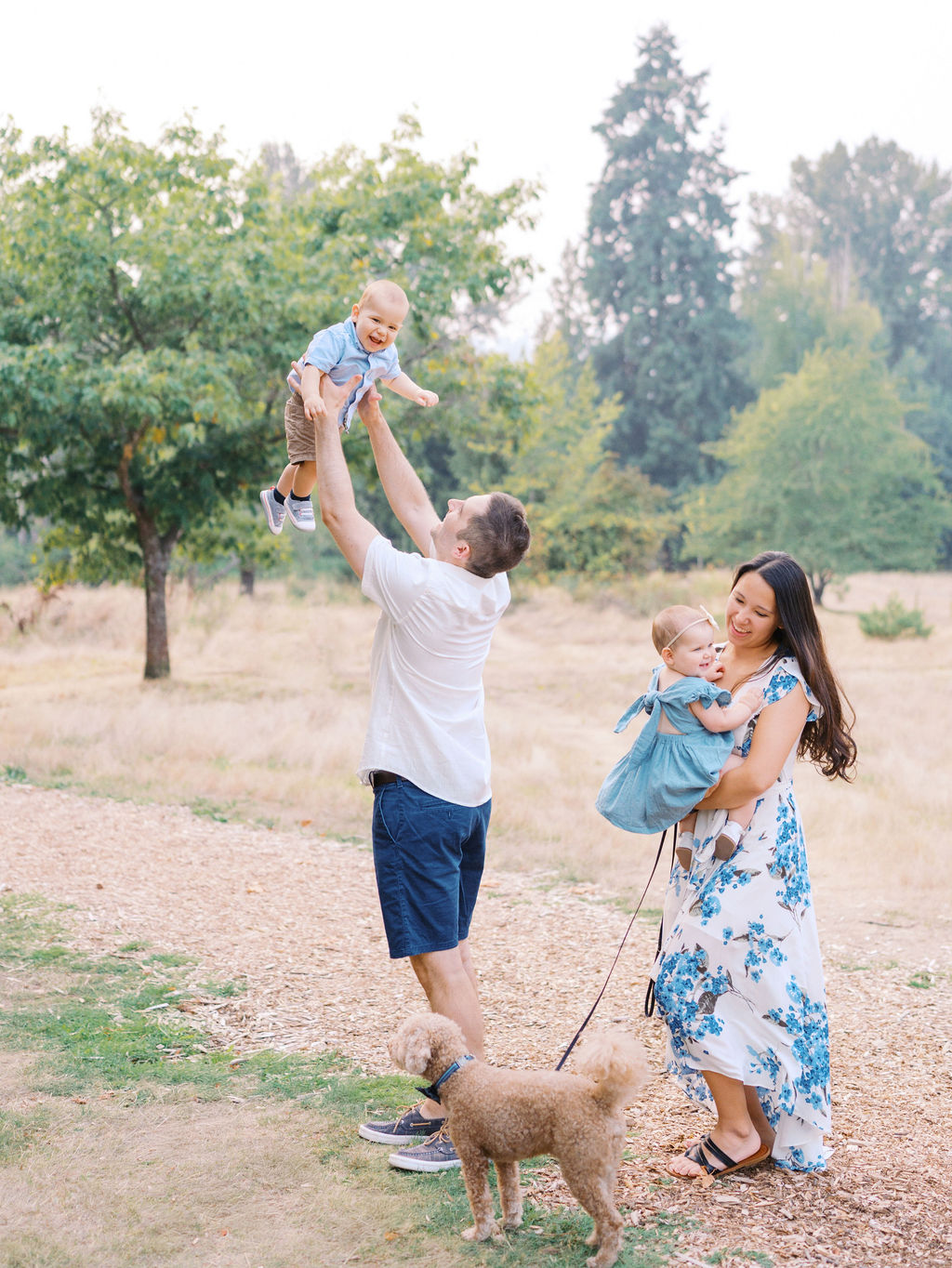 Mom dad and twins laughing at a full family session with Seattle family photographer Tanya Zagumenov