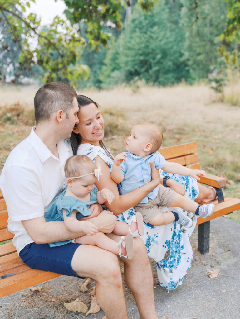 Family sitting on a bench in a Seattle park by Seattle Family Photographer Tanya Zagumenov