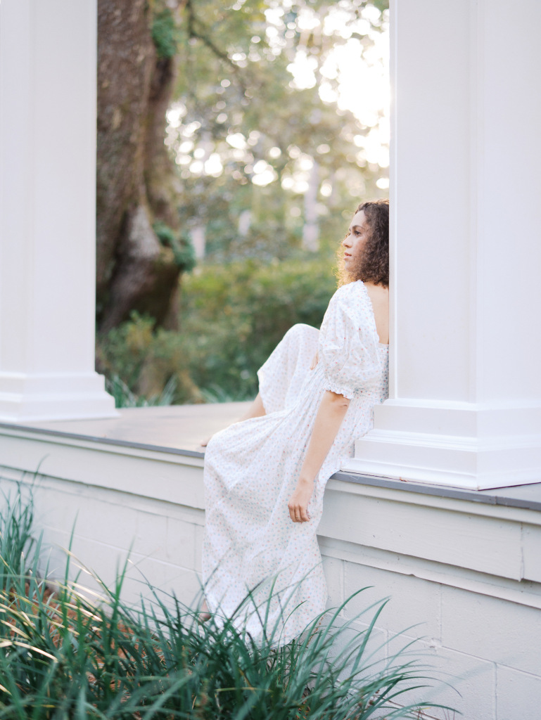 Pregnant woman sitting on a porch captured by Seattle maternity photographer Tanya Zagumenov