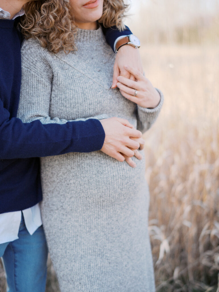 A close up of a pregnant belly during a maternity photo shoot
