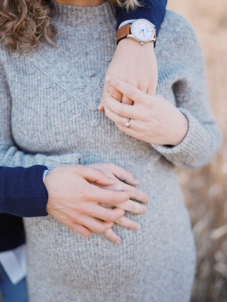 Closeup of a pregnant belly of a couple exploring prenatal care options in Seattle