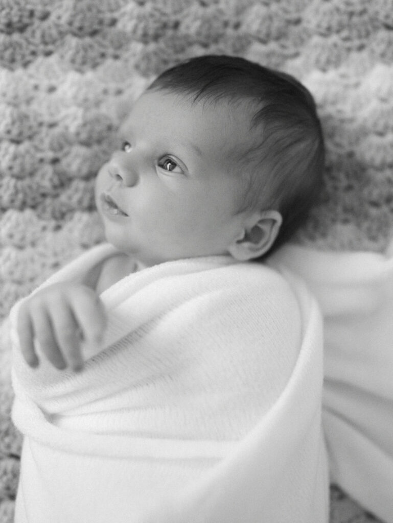 Black and white image of a swaddled baby girl
